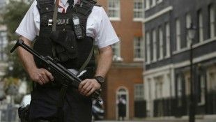 An armed police officer is seen on duty in Downing Street, central London
