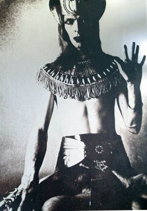 Bowie dressed in Egyptian garbs (like Crowley used to do) and displaying the hand sign of “as above so below” 