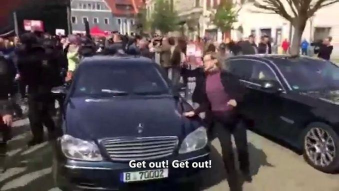 German minister flees crowd after they shout "traitor"