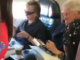Clintons caught flying commercial, reading book about child rape