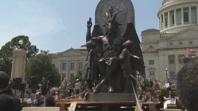 A giant goat-like statue of Baphomet was unveiled Thursday on the lawn of the Arkansas State Capitol in Little Rock in front of a baying media pack and supporters who chanted "Hail Satan."   