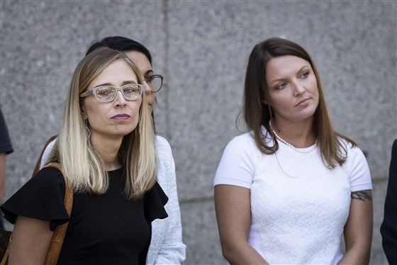 Annie Farmer, left, and Courtney Wild, right, look on as their lawyers speak to the press at federal court following a bail hearing for Jeffrey Epstein on July 15, 2019 in New York.