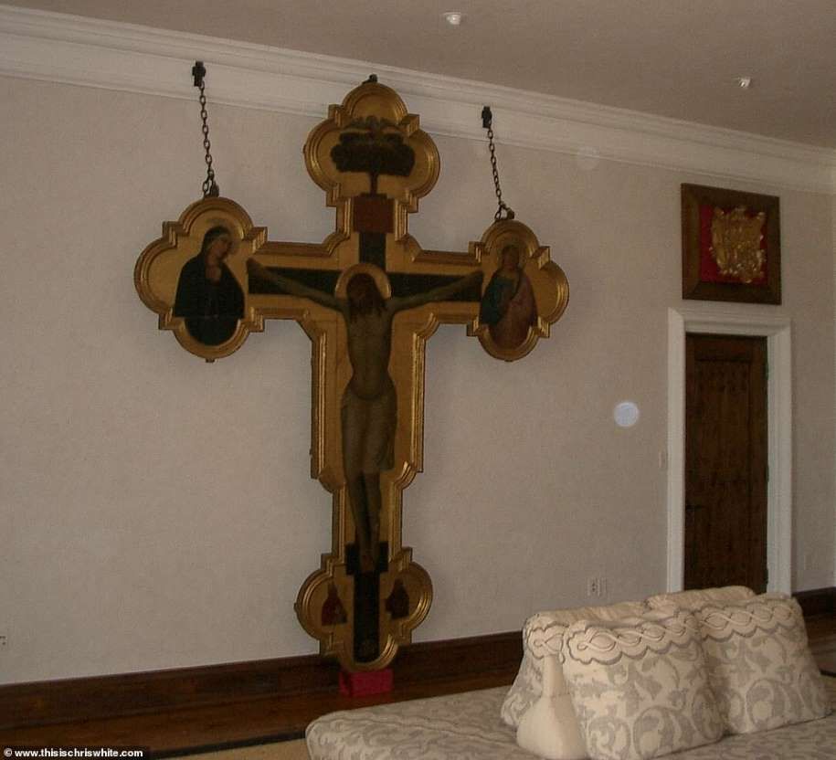 One of the bedrooms has a sculpture of a life-sized Jesus crucified on a golden cross, which covers most of one wall and is attached by chains to the crown molding