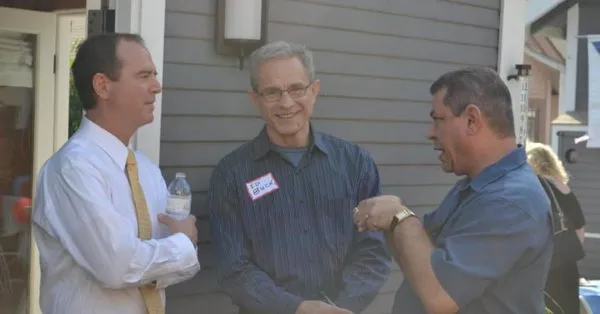 Rep. Adam Schiff and Ed Buck (center) outside a house in California.