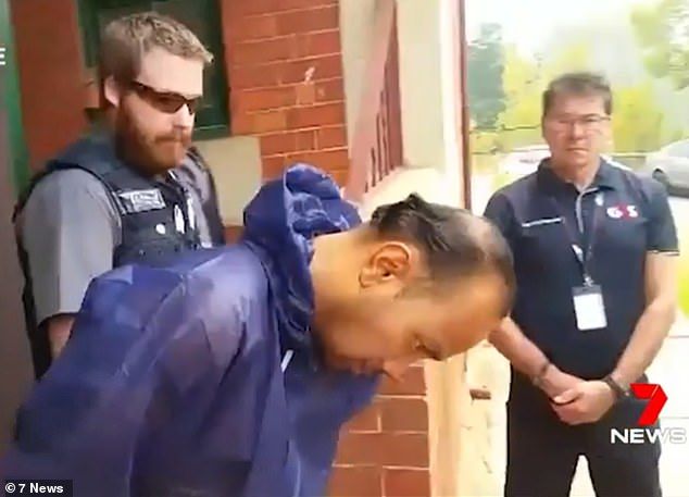 Michael Truong is led from Bairnsdale Magistrates' Court after his arrest 