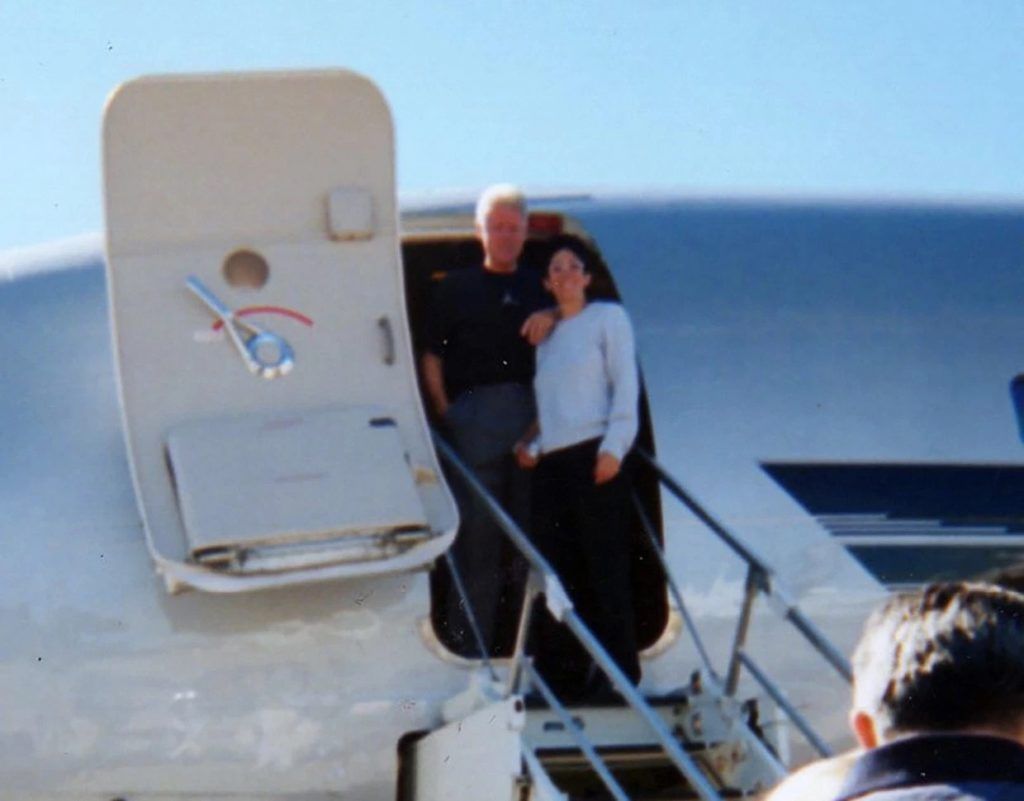 Bill Clinton and Ghislaine Maxwell pose at the door of Epstein's private jet