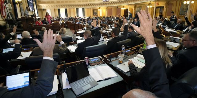 Republican members raise their hands to ask for a recorded vote on one of several gun-related bills during the floor session of the House of Delegates in Richmond, Va last month. (Bob Brown/Richmond Times-Dispatch via AP)