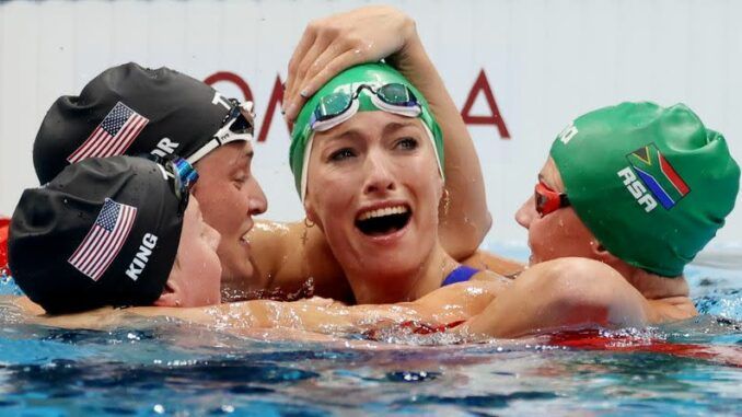 Olympic swimmer with 'glory to god' cap wins gold, smashing world records